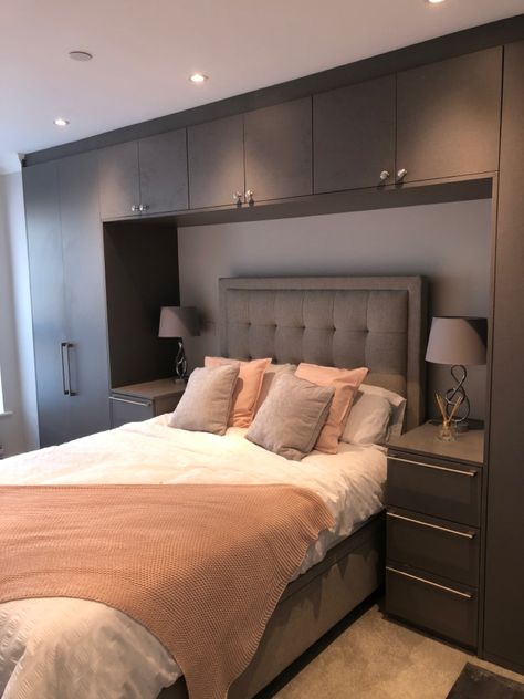 Are you looking for a fitted wardrobe that makes a statement? This is an anthracite linen finish that real does make a huge impact in this bedroom whilst creating plenty of storage space around the bed. Wardrobes Over The Bed, Modern His And Her Bedroom, Bed Wardrobe Design Modern, Bedroom With Built In Wardrobe Around Bed, Bedroom Layout With Built In Wardrobe, Bed Beside Wardrobe, Master Bedrooms Decor With Storage, Wardrobe Beside Bed Small Spaces, Bedroom Wardrobe With Bed