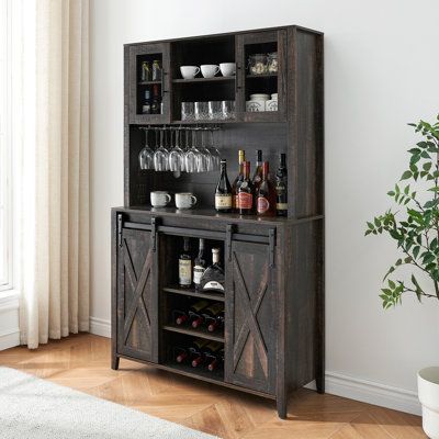 Featuring two flexible sliding barn doors, this rustic wine cabinet provides easy access to storage while saving space. The sliding door with the farmhouse sign creates an elegant, farmhouse ambiance in your living space. Flexibly use it as an alcohol cabinet, kitchen pantry, china cabinet, coffee bar station, microwave stand, kitchen cupboard, credenza, and storage cabinet. | Ebern Designs (white)70" Rustic Buffet Cabinet w/ Storage Shelves Liquor Cabinet w/ Wine Rack Brown 69.6 x 47.2 x 15.7 i Rustic Buffet Cabinet, Symmetrical Aesthetic, Rustic Wine Cabinet, Alcohol Cabinet, Cabinet Coffee Bar, Coffee Bar Cabinet, Farmhouse Bar, Farmhouse Coffee Bar, Wine Bar Cabinet