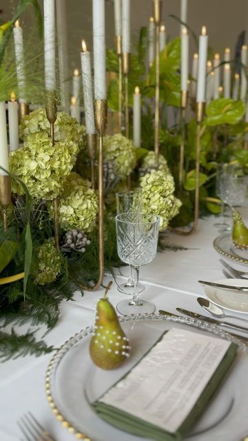 MODERN HERITAGE STYLING on Instagram: "SYMPHONY//

We had a great time yesterday at @norwoodng25 wedding fair, it was brilliant to meet so many excited couples ready to plan their big day!

 @jacaranda_flowers and I brought our ‘Symphony’ with a stunning tablescape featuring on- trend floral groupings and decadent modern candle decor that hit all the right notes!

We carried the look through every detail from charger plates and napkins to stationery and chair decor. We also added in various fruits for texture, colour and added luxe.  Everything was in perfect harmony. 

If you’re feeling inspired and would like to create unforgettable moments for your big day get in touch today!
.
.
.
#tablescape #romanticweddingbreakfast #candlelight #weddingtablescape #statementflorals #pearls #weddingin Moss Table Scape, Mossy Tablescape, Moss Table, Green Monochromatic, Modern Heritage, Modern Candle, Candle Wedding Centerpieces, Chair Decor, Candle Wedding