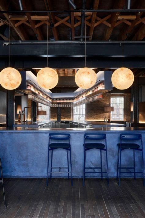 Dark woods and moody blue hues evoke the piney notes and sharp flavour of juniper berries inside Sydney’s Four Pillars gin emporium in Surry Hills.  The Yarra Valley-based distillery’s hub includes a gin lab, bottle store and a cocktail bar designed by Yasmine Saleh Ghoniem.  Photography: Anson Smart   #sydney #australia #design #interiors #interiordesign #interiorstyle #travel Brewery Restaurant Design, Navy Blue Bar, Dark Blue Bar, Gin Bar Design, Navy Restaurant Interior, Dark Bar, Dark Blue Bar Aesthetic, Bar Counter Design Home, Blue Lights Bar