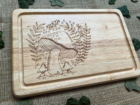 Mushroom chopping board, Engraved bread board, House warming gift, Personalised house warming present, Cottage core gift, Mushroom lover #woodslicemagic #diyhomedecor #sustainablecrafts #naturalart #woodslicedecor #diygiftideas #Woodworking #WoodworkingTips #WoodworkingProjects #WoodworkingIdeas #WoodCraft #WoodArt #DIYWoodworking #WoodworkingCommunity #HandmadeWoodwork #WoodworkingSkills #WoodworkingLife #WoodworkingInspiration #WoodworkingCrafts #WoodworkingDesign #DIYWoodGingerbreadHouses Board House, Wood Slice Decor, Wood Burn Designs, Spoon Crafts, Cutting Board Design, Woodworking Inspiration, Wood Burning Crafts, Wood Burning Patterns, Wood Burning Art