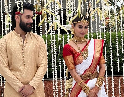 Mouni Roy tied the knot with her Dubai-based boyfriend Suraj Nambiar in Goa today with close friends and family in attendance. Mouni's long-time friend and her Naagin co-star Arjun Bijlani shared a picture of the bride and groom from the wedding ceremony.Sharing a picture of Mouni and Suraj Nambiar on Instagram, Arjun Bijlani captioned it as, “Mr and Mrs Nambiar!!”. The couple never officially confirmed dating each other.The pre-wedding functions took place in Goa on Wednesday. On Wednesday, pic White Saree Wedding, Red And White Saree, Bridal Sarees South Indian, Telugu Wedding, Mouni Roy, Bengali Wedding, Celebrity Wedding, White Saree, Indian Groom