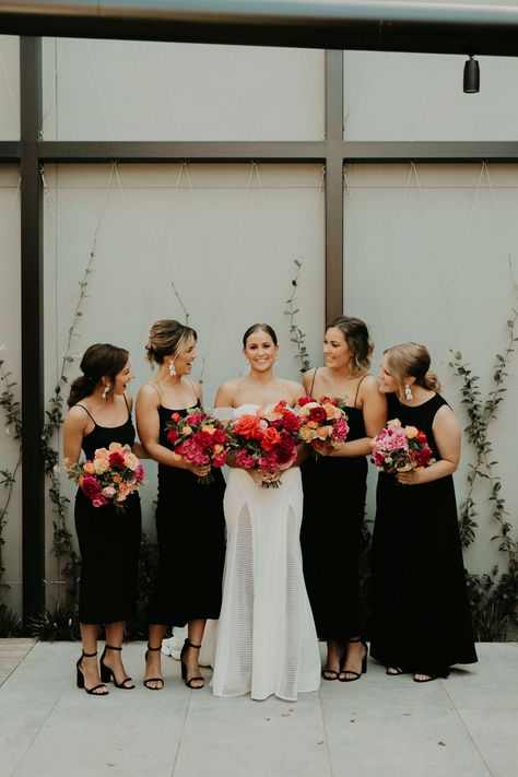 Black Wedding Party Bridesmaid, Bridesmaids In Black Dresses Bridal Parties, Mix And Match Bridesmaid Dresses Jewel Tones, Black Bridesmaid Dresses With Colourful Flowers, Fun Bridal Bouquets, Black And Color Wedding, Black Bridesmaid Dress Colorful Bouquet, Black Wedding Colorful Flowers, Colorful Floral Arrangements Wedding