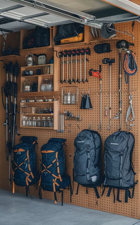 A garage with a pegboard backpacking gear wall displaying organized outdoor gear and backpacks. Hiking Gear Storage Wall, Outdoor Gear Storage Garage, Hiking Gear Storage Ideas, Hiking Gear Wall, Camping Gear Storage Garage, Ebay Storage Ideas, Gear Closet Organization, Organize Camping Gear, Camping Gear Storage Ideas