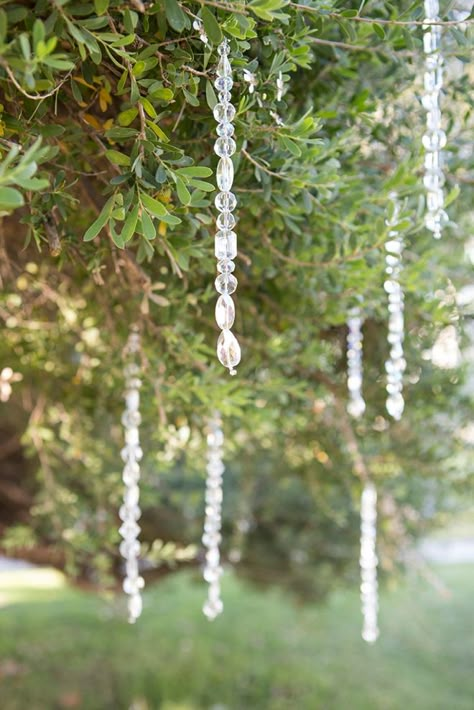 These gorgeous tree crystals are SO easy to make, learn how in this blog post! Suncatcher Wedding Decor, Crystals Hanging From Trees, Things To Hang From Trees Outdoors, Wedding Decor Crystals, Wedding Crystal Decor, Decorated Trees For Weddings, Crystal Wedding Decorations, Tree Decoration Wedding, Hanging Crystals Diy