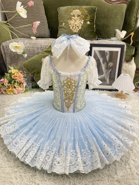 Professional bell-shaped tutu for the Wedding Pas de Deux in the ballet "Coppelia". White and pale blue brocade bodice with central white insert with gold decorations. Round neck decorated with white lace frills, pink and yellow flowers appliques, and pink satin ribbons. Round deep back and hooks and eyes closure. White short lace sleeves attached to the nude straps. The bell shaped tutu skirt is made with four layers of pastel color tulle (blue and pink), and features a white French lace overlay embellished with rhinestones. Custom made. Delivery time: 6 to 8 weeks. $ 650 Pink Tulle Skirt Outfit, Alice In Wonderland Ballet, Classical Ballet Tutu, Tulle Skirts Outfit, Dance Comp, Ballet Tutus, Gold Decorations, Ballerina Costume, Pink Tulle Skirt