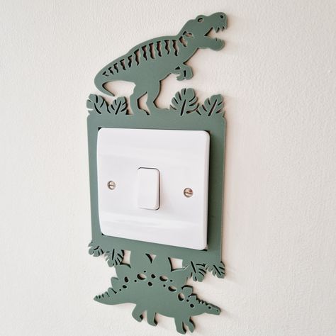 These ROARSOME dinosaur design light switch surrounds are the perfect addition to any bedroom, playroom or nursery. Designed to fit comfortably around a standard 86x86mm single light switch. Choose from two different designs, featuring a T-Rex with a Stegosaurus or a Pteranodon. Both designs are available in over 25 matte acrylic colours, to suit any décor.  This jurassic-themed light decoration also makes a thoughtful gift for baby showers, birthdays, and other special occasions. It can easily be mounted on the wall or door with 3M Command Strips or similar (strips not included).  **This surround is for decorative purposes only and is not a toy.** ------ GIFTS: We can enclose a little message free of charge if this item is for a gift. Simply message us when you order! We can also send the Dinasour Bathroom Ideas, Baby Nursery Dinosaur Theme, Subtle Dinosaur Bedroom, Boys Room Theme Ideas, Dinosaur Baby Room Nurseries, Dinosaur Furniture, Dinosaur Room Ideas, Dinosaur Bedroom Ideas, Dinosaur Nursery Baby Boy