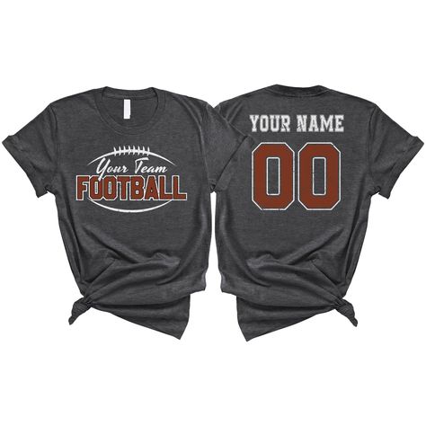 PRICES MAY VARY. PERSONALIZED T-SHIRT: A personalized Football T-shirt with name and shirt number will be the perfect gift for football lovers, mom, daughter, sister, niece, Wife, girlfriend,... Click on "Customize Now" and and start designing your unique shirt. MATERIAL: Solid colors are 100% cotton ( Black, White, Navy , Forest Green). Dark Heather colors are 50% cotton, 50% polyester. Sport Grey and Athletic Heather 90% cotton, 10% polyester. Color Dark Gray Heather and Heather Mauve 52% cott Saints Football Shirts, Sports Mom Fashion, Flag Football Shirts Design, Football Diy Shirts, Football Fan Shirts High School, Cute Football Shirts Ideas, Aunt Football Shirt Ideas, Football Mom Shirts Ideas Design, Football Spirit Wear