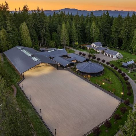 HorseProperties.Net® on Instagram: "LOST LAKE FARM - A CAPTIVATING MASTERPIECE ON 23 ACRES | Snohomish, Washington Lost Lake Farm, destined to be a NW Landmark in Equestrian living. A captivating masterpiece built in 2019 sited on over 23 perfected acres. Unparalleled State of the art horse facilities, 19 stalls, 80 x 200 covered arena blends seamlessly into a 110 X 200 outdoor portion for a total of 400' length. Hoofgrid paddocks, heated viewing rm, steel board fencing and countless equine amenities. Over 5000 SF Modern Farmhouse offers grand Great Room design w/ massive pocket doors opening to a forested backdrop & outdoor living spaces. The home and its surroundings were thoughtfully designed and executed with a no expense spared approach from start to finish. 2 gated entries, updated 2 Equestrian Center Design, Modern Stables Architecture, Paddocks For Horses, Texas Horse Ranch, Luxury Stables Exterior, Outdoor Horse Stalls, Horse Property Layout, Horse Arena Fencing, Modern Horse Barn