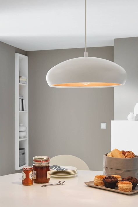 The Mogano 1 is a single pendant fitting with rounded shade and metallic flair. The pendant has a white steel finish with contrasting inner copper shade, which reflects beautifully when illuminated. The Mogano 1 requires 1 x E27 lightbulb. This style of pendant would complement a range of interiors from retro-inspired to contemporary due to its sleek and eye-catching design. This light is IP20 rated, suitable for interior use only. Standard 2 year warranty.  100% Steel. Pendant Lighting Over Dining Table, Dining Table Lights, Dining Table Pendant Light, Lights Over Dining Table, Kitchen Table Lighting, Round Table Lamp, Living Room Pendant Light, Copper Interior, Round Kitchen Table