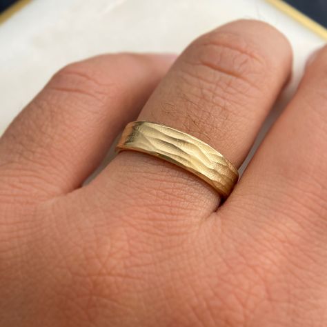 Details: 10k or 14k gold, sterling silver Horizontal wave finish 6mm wide, 1.2mm thick Polished edges and interior Gentle comfort fit interior edge Available in quarter sizes by request For platinum, or 18k gold or higher, karat please email us for a quote Style: Our Unique Gold Band Ring Inspired by Serene Beaches Imagine capturing the essence of summer and the tranquility of a beach within a ring – our Gold band ring does just that. Inspired by the gentle waves etched in the sand and the peace Thick Gold Band, Gold Wave Ring, Wave Ring, Montana Sapphire, Gold Band Ring, Enamel Ring, Salt And Pepper Diamond, Wedding Board, Emerald Ring