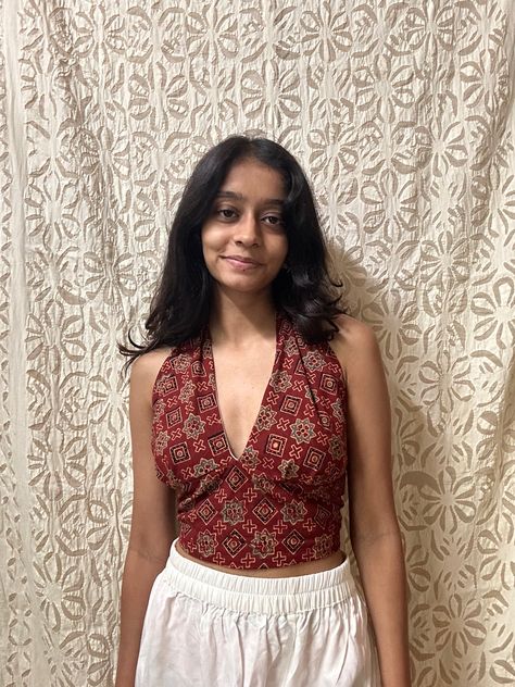 this beautiful maroon halter neck top is from a small business on instagram, They have beautiful tops with a touch of indian prints! Comment to get the name of this store #halternecktop #aesthetictops #traditionaltops #halterneck #outfits #fashion #ootd Halter Neck Tops Outfit, Cotton Halter Top, Halterneck Saree Blouse, Tops From Saree, Halter Neck Short Kurti, Indian Print Tops, Halter Neck Top Outfit Casual, Indian Boho Fashion Outfits, Indian Tops With Jeans