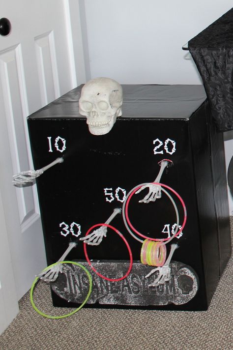 Michael’s Halloween Crafts, Diy Cardboard Halloween Games, Halloween Trick Or Treat Ideas At Home, Skeleton Ring Toss, Skull Toss Carnival Game, Carnevil Halloween Party Games, Halloween Whats In The Box Game, Halloween Ring Toss Game Diy, Kid Games For Halloween Party