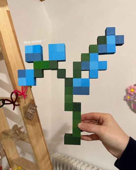 blue orchid from Minecraft 🫧 Blue Orchids Minecraft, Wood Block Minecraft Flower, Wooden Cube Minecraft, Blue Orchid Minecraft, Minecraft Wood Block Craft, Minecraft Flower Pixel Art Grid, Flower Pixel Art Grid, Minecraft Flowers, Diy Minecraft Decorations