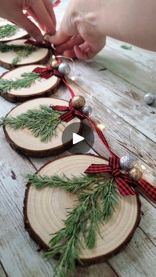 DIY Christmas Wood Slice Garland | Here's the video for the wood slice Christmas garland using my own dried pressed juniper ✨️🎄I hope y'all enjoy the video!   Also, thank you so much for... | By Love Crafted Decor | Hey y'all here's how I made the Christmas Wood Slice Garland so I'm using real pressed juniper that I got off of my own little juniper bush in my yard I got these wood slices off of Amazon and I'm just gluing the pieces of pressed juniper to the wood slices and then I'm feeding through a little piece of twine to make them into a little hanger and you could honestly use all these same steps to make these into ornaments instead if you don't want to make this into garland and then just add a little color to them I'm using this buffalo check mini bows and y'all I'm still working o Christmas Decorations Wood Slices, Diy Wood Slice Ornaments For Kids, Craft With Wood Slices, Things To Make With Wood Slices, Wooden Christmas Garland, Christmas Crafts With Wood Slices, Wood Slice Crafts Diy Ideas, Tree Slices Ideas, Wood Slices Christmas Ornaments