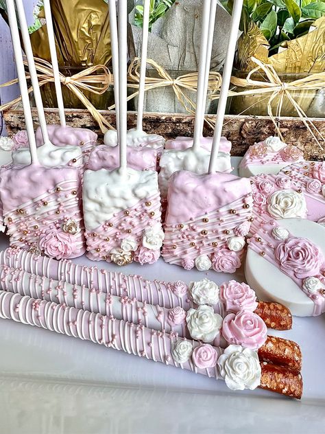 This gourmet White and pink colored Chocolate treats party bundle contains the below listed gorgeous confections. Each treat will be dipped in pink and white colored chocolate and then dazzled with a drizzle, nonpareils and chocolate flowers. If you need a larger quantity please message me for a custom order.  12 Pretzel Rods  12 Chocolate Covered Oreos  12 Rice Krispie treats  Each treat will be individually wrapped in a crystal clear cellophane sleeve and tied with color coordinating ribbons or ribbon color of your choice.  Delightful Chocolates cannot be held responsible for melted or broken chocolate once the package has left our possession. We also cannot be held responsible for how the postal service treats or handles our packages. We take great pride in insulating our boxes and pack Pink And White Rice Krispie Treats, Pink Treat Table, Pink And Gold Dessert Table, Treat Table Ideas, Pink Birthday Decor, Pink And White Birthday, Sweets Business, Colored Chocolate, Dipped Treats