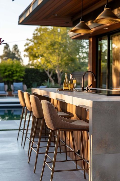 Backyard outdoor kitchen bar with modern outdoor bar stools next to pool Bar Counter Outdoor Design, Outdoor Barstool Ideas, Outdoor Island Ideas, Outdoor Bar Styling, Outdoor Counter Bar, Covered Bar Outdoor, Outdoor Bar Area Ideas, Bar Outside Ideas Patio, Boho Outdoor Kitchen