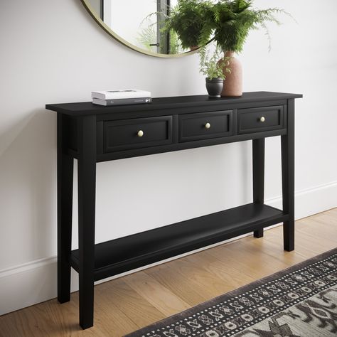 Features we love A classic farmhouse design for a warm homely feelThree drawers plus one lower shelf for supreme storageA smooth black painted finishCome with 2 handles options silver and goldAn elegant narrow design for slim spaces All about meMaximise your space and discover the perfect finishing touch for any hallway. This narrow console table has been beautifully finished in a sleek black with two options for your handles to complement most room themes and colour palettes. Pick and choose ho Black Console Table Entryway Gold Mirror, Narrow Hall Table Ideas, Small Hallway Table Ideas, Black Hall Table, Hall Console Table Ideas, Black Hallway Table, Narrow Entrance Hall Ideas, Black Console Table Entryway, Black Console Table Decor