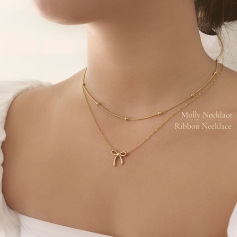 A Delicate Ribbon Pendent Necklace - This listing is for one necklace. Perfect for layering and everyday wear. - Material: High Quality Stainless Steel- Finish: 18k Gold- Measurement: 16" + 2" extender- Nickel Free and Tarnish Free- All our jewelry is packaged in gift-ready boxes. If you would like multiple items from your order packaged separately please let us know!© 2023 Generation of Daughters Necklace Simple Design, Cute Jwellary Aesthetic, Jewelry From Movies, Simple Gold Pendent Designs, Pendent Designs Gold, Classy Jewelry Gold, Gold Necklace Aesthetic, Jewelry Accessories Aesthetic, Pendent Design