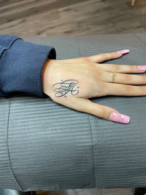 calligraphy hand tattoo Hand Tattoo Name For Women, Letter Initial Tattoo Placement, Where To Put Name Tattoos, Hand Tattoo Baddie, Thumb Tattoos Side Words, K Hand Tattoo, La Hand Tattoo, Initial Tattoo Hand, Hand Initial Tattoo