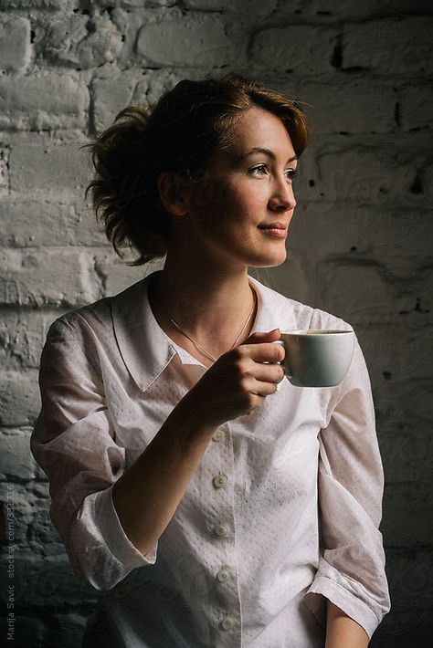 Woman Holding a Cup of Coffee  by Marija Savic for Stocksy United Holding Tea Cup Pose, Holding Cup Of Tea Reference, Hand Holding Tea Cup Reference, Coffee Holding Pose, Person Holding Teacup Reference, Woman Holding Coffee Cup, Holding A Coffee Cup Pose, Holding Mug Pose Reference, Sipping Tea Pose Reference