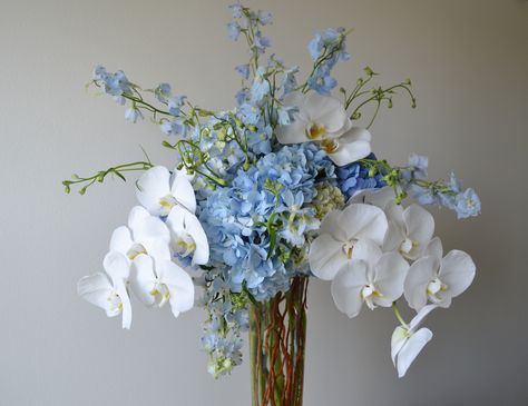 Light Blue Orchids, Blue Orchid Centerpieces Wedding, Blue Orchid Arrangements, Blue And White Hydrangea Arrangements, White Hydrangea With Blue Delphinium, Blue Delphinium Wedding Bouquet, Blue Hydrangea Bouquet Aesthetic, Orchid Hydrangea Bouquet, Blue White Floral Arrangements