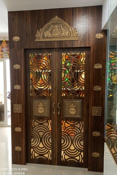 Artisticks pooja room door accessories are the best companions for the perfect pooja doors, which bring an artistic touch along with a traditional look. Our stunning range of pooja room doors designs is sure to give you designs that fit your desires. Accessories are arranged from the top to bottom of the Pooja doors and are equally spaced, making them symmetric and beautiful. #poojaroomdoor #poojadoor #poojaroomideas #poojadoorideas #Poojaroom Chettinad Pooja Room, Unique Pooja Room Door Design, Pooja Room Top Design, Puja Room Door Design Indian Traditional, Pooja Room Door Design Glass And Wood, Pooja Room Inside Design, Pooja Door Design Modern, Pooja Room Door Design Traditional, Traditional Pooja Room Design