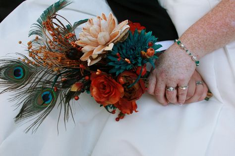 Peacock feather bouquet with silk and dried flowers Bridal Bouquet With Peacock Feathers, Flowers With Peacock Feathers, Peacock Feathers Wedding Decor, Peacock Feather Arrangements, Flower Bouquet With Feathers, Peacock Feather Wedding Bouquet, Bouquet With Peacock Feathers, Peacock Feather Bouquet, Peacock Wedding Colors