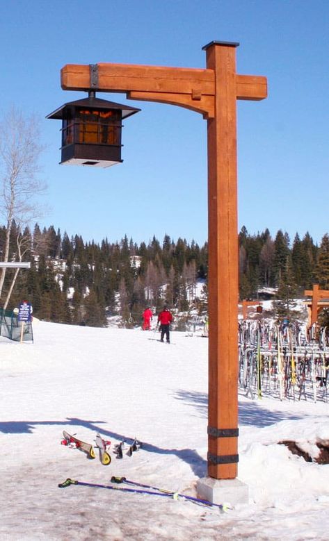 Custom wood built light post at a ski resort with a gas lantern hanging from it. Skis and snow surrounding it.  Caribou Creek Log Homes builds more than just houses. We build specialty item such as staircases, entry ways, sign posts, and custom furniture. #Cariboucreekloghomes #handcraftedlogstructures #handcraftedstaircase Rustic Light Post Outdoor, Driveway Posts, Garden Lamp Post, Driveway Lighting, Lantern Hanging, Outdoor Lamp Posts, Light Post, Lantern Post, Log Home