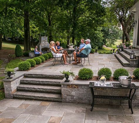 Tiered Patio Ideas Sloped Yard, Paver Deck Raised, Stone Patio With Steps, Tiered Patio Ideas, Downslope Backyard Ideas, Concrete Patio Sloped Yard, Two Tier Patio, Outdoor Hardscape Ideas, Deck On Sloped Yard