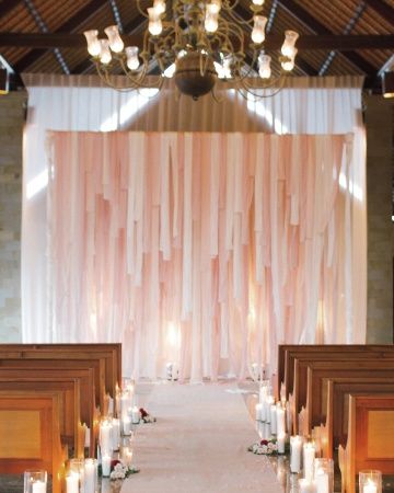 Flowers, candles, and fabric strips transformed this spare ceremony space. Dark or generic church for your ceremony? DIY it to spruce it up! Ribbon Backdrop, Boda Diy, Hunting Party, Wedding Ceremony Backdrop, Festa Party, Bali Wedding, Favor Ideas, Peach Wedding, Martha Stewart Weddings