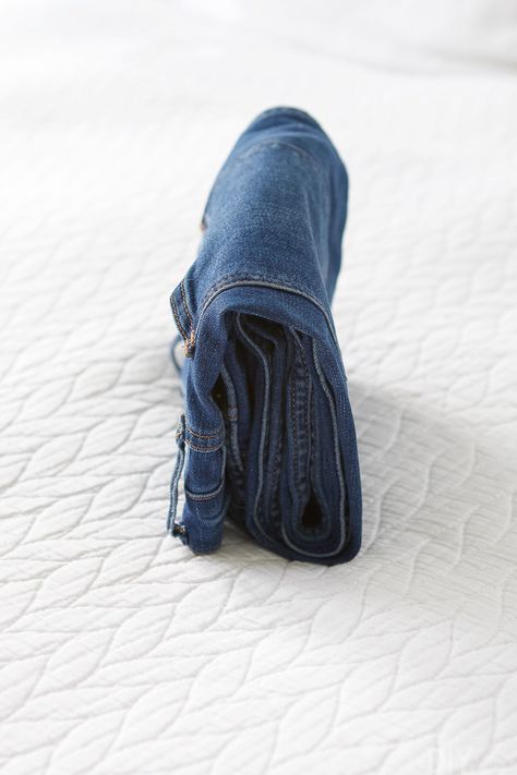 How to Do The Marie Kondo Fold for Clothing | The DIY Playbook Jeans Storage Ideas, Jeans Storage, Denim 2024, How To Fold Jeans, Clothes Folding Board, Shirt Folding Board, Jean Organization, Konmari Folding, Marie Kondo Organizing