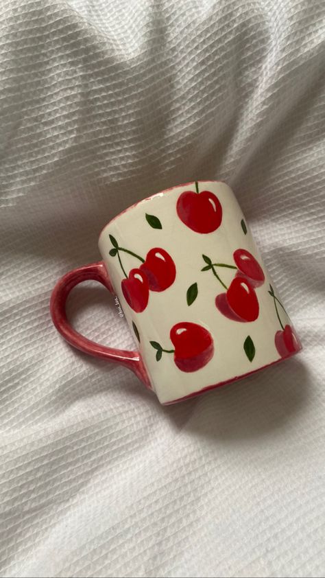 painted cherry mug on duvet Cherry Pottery Mug, Aesthetic Cup Painting, Mug Paint Designs, Cherries Pottery Painting, Diy Cup Painting, Painting On Cups Ideas, Cherry Mug Painting, Paint On Mugs Diy, Cherry Ceramic Mug