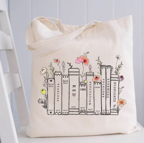 Albums As Books Taylor Swift Tote Bag Check more at https://onismapparel.com/product/albums-as-books-tote-bag/ Book Taylor Swift Aesthetic, Taylor Swift Album As Books, Tote Bag For Books, Toat Bags Design Diy, Painting On Canvas Bags Totes, Taylor Swift Totes, Cute Canvas Tote Bags, Totebag Painting Ideas Taylor Swift, Taylor Swift Bag Ideas