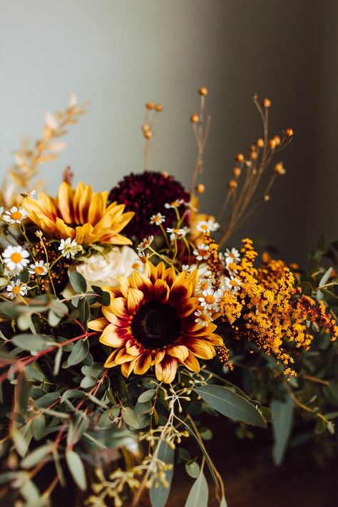 These mini sunflowers were so sweet for this intimate fall backyard wedding day! The warm tones mixed with fresh greenery created a natural and romantic style. For more backyard wedding inspiration, check out our blog! Mums And Sunflower Wedding, Wedding Decor With Sunflowers, Fall Wedding Greenery, Fall Sunflower Bouquet, Fall Flower Wedding, Plum Sunflower, Sunflower Fall Wedding, Wedding Wild Flowers, Fall Decor Crafts