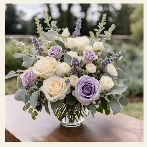 Deepest Sympathies Floral Arrangement Description: Express your heartfelt condolences with our exquisite "Deepest Sympathies Floral Arrangement." This thoughtfully curated bouquet combines the timeless elegance of lavender and white roses, creating a serene and comforting display that conveys your deepest sympathies. Standard: A fuller bouquet for those who want a bit more floral beauty: 12" L x 12" W x 16" H Traditional Elegance: A statement piece that’s sure to impress: 14" L x 14" W x 20" H E Purple And White Flower Arrangements Centerpieces, Sterling Roses Bouquet, Lavender Hydrangea Centerpiece, Lavender Wedding Arrangements, Lavender And White Centerpieces, Lavender And White Flower Arrangements, Fresh Floral Centerpieces, Simple Purple Flower Arrangements, Wedding Flowers Purple Lavender