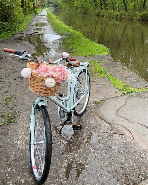 Vintage style bike with wicker basket on the front. Pink bell. Pale blue bike with pink flowers in the basket. Set by the canal. Bike Vintage Aesthetic, Vintage Bicycles Aesthetic, Cute Bikes With Basket, Bikes With Baskets, Bike With Basket Aesthetic, Vintage Bikes With Basket, Aesthetic Bikes, Cycle Aesthetic, Pretty Bicycle