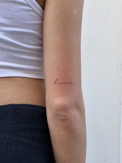 Small Tattoo Back Of Arm Above Elbow, Dainty Cursive Tattoo Arm, Writing On Back Of Arm Tattoo, Small Word Tattoos For Women Arm, Back Arm Word Tattoo, Dainty Tattoos Writing, Dainty Feminine Tattoos Arm, Fineline Tattoo Script, Dainty Tattoo Words