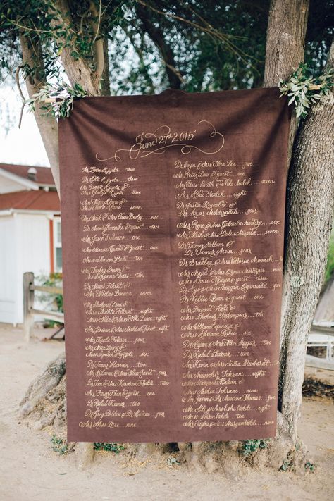 Guest table assignments were calligraphed in gold (by Perfect Fête Designs) onto chocolate-brown velvet, inspired by a classic regal scroll but using fabric instead of paper. Velvet Wedding Ring Box, Velvet Seating, Wedding Ring Boxes, Velvet Invitation, Mirror Seating Chart, Copper Fabric, Rustic Arrangements, Invite Suite, Table Assignments