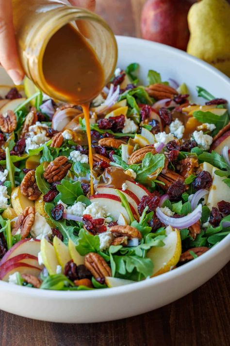 This Autumn Pear Salad recipe is simple but stunning. Combining sweet pears, fresh arugula, tangy Craisins, and crunchy nuts is the perfect blend of flavors and textures. Salad With Croutons Recipes, Pear Spinach Salad Recipes, Autumn Side Salad, Fall Salads For Thanksgiving, Salad With Roasted Potatoes, Pear Salad With Balsamic Dressing, Salad With Mixed Greens, Lite Salad Recipes, Autumn Pear Salad