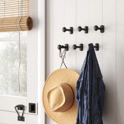 This set of six wall hooks is sure to accentuate your home with a functional rustic design. They're made from cast iron and have a nailhead-like silhouette for an industrial, farmhouse-inspired design that looks great on any wall. Line them up along your entryway to hang coats, jackets, bags, scarves, hats, and keys, or spread them out and use them throughout your home. This set of hooks arrives with anchors and screws to make installation a breeze. | Sand & Stable™ Quaile Metal 6 - Hook Wall Ho Wall Hook For Clothes, Mudroom Coat Hook Ideas, Entryway Hooks And Bench, Hooks On Wall Entryway, Boho Remodel, Rustic Towel Hooks, Black Wall Hooks, Decorative Coat Hooks, Metal Wall Hooks