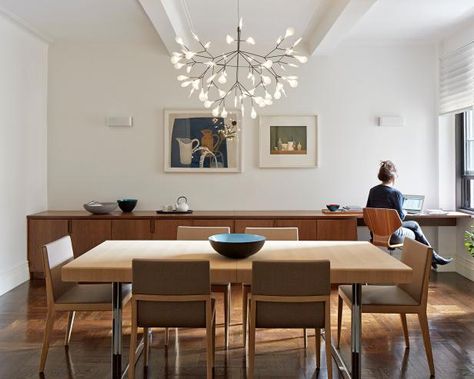 Modern dining rooms will find their perfect match in a sleek, wall-to-wall buffet table like this. Because the storage unit is so long, it doesn't need to be very wide, which allows the homeowners to enjoy more floor space. Notice, too, how architect James Wagman purposefully oriented the unit to sit parallel to the table; this technique helps showcase the clean lines of each piece and takes advantage of the most wall space. Ceiling Lights Uk, Dining Room Ceiling Lights, Stylish Dining Room, Dining Room Ceiling, Dining Room Buffet, Dining Room Light Fixtures, Empty Nest, Dining Room Storage, Dining Lighting