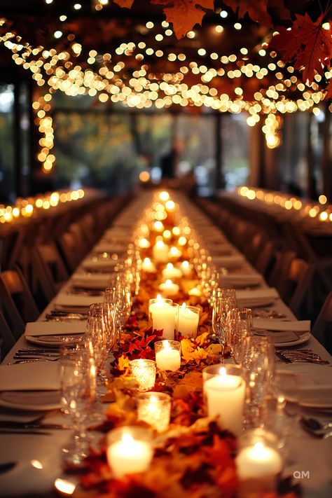 A long table adorned with fall candles, autumn leaves, and string lights creates an intimate setting for a stunning wedding in autumn. Fall Wedding Tables. November Wedding Indoor, Evening Fall Wedding, Fall Wedding Memory Table, Cabin Theme Wedding, Harvest Moon Wedding Theme, Small October Wedding, Fall Wedding Lights, October Wedding Ceremony Decor, Wedding Theme Sunflowers