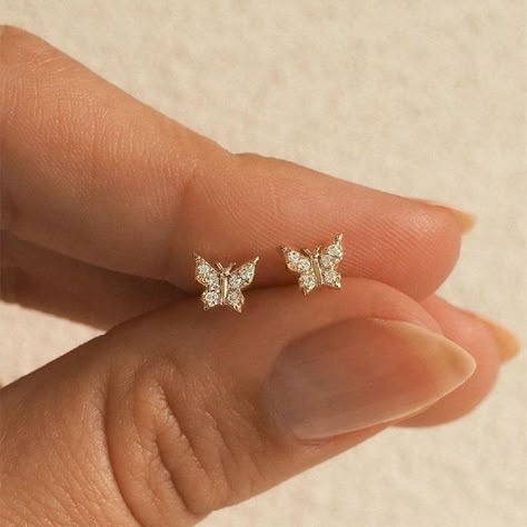 Mini Butterfly Stud Earrings -------------------------------------- These gorgeous earrings are created with high-quality 18k gold-plated solid silver.  Great for sensitive ears and a sleeper earring, so you don't have to take it off when you go to bed at night.  It's the perfect dainty dreamy earring to add to your ear stack.  Many believe that the butterfly is a representation of resurrection, change, renewal, hope, endurance, and courage to embrace the transformation to make one's life better Eat Piercings, Small Earrings Gold, Dainty Gold Earrings, Butterfly Earrings Gold, Fancy Jewellery Designs, Butterfly Earrings Stud, Piercing Ideas, Classy Jewelry, Fancy Jewellery