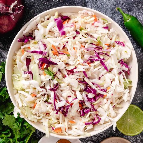 Here’s the perfect Mexican slaw for fish tacos! Used as a crunchy taco topping, this easy recipe combines fresh cabbage, carrots, and a zesty cilantro-lime dressing. It’s great for quick weeknight Taco Tuesdays or family gatherings, and the best part—there’s no mayo! Fish Taco Cabbage Slaw Recipes, Shrimp Taco Slaw, Fish Taco Coleslaw Recipe, Coleslaw For Fish Tacos, Fish Taco Cabbage Slaw, Cabbage Slaw For Tacos, Fish Tacos With Cabbage Slaw, Slaw For Tacos, Slaw For Shrimp Tacos