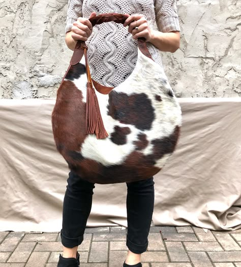 "Add lining to any of our bags https://www.etsy.com/listing/891051352 Unique cowhide leather hobo bag, with brown braided strap and two tassels (included) Measurements- 19\" wide x 19\" high 14\" high in the middle This is a large size, slouchy, handmade leather bag, with feminine design and a braided black strap. Made with soft hair on leather leather. The bag is great for your daily essentials, perfect for everyday use, or for a special occasion. It can hold your school items, groceries, walle Luxury Designer Calf Leather Hobo Bag, Luxury Textured Leather Bucket Hobo Bag, Luxury Textured Leather Hobo Bag For Travel, Luxury Fall Hobo Bag With Top Handle, Luxury Calf Leather Bags With Leather Backing, Luxury Bucket Hobo Bag With Multiple Compartments, Luxury Brown Calf Leather Hobo Bag, Luxury Pebbled Leather Hobo Bag With Leather Lining, Luxury Designer Bucket Hobo Bag