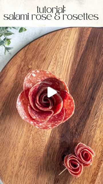 1,071 likes, 8 comments - charcuterie_n_things on June 26, 2024: "🌹How to Make Salami Roses and Rosettes🌹 Salami Roses 1. Tools: 2oz condiment cup and 11 salami slices 2. Layer: Place 5 slices halfway over the first one around the cup. 3. Create the bud: Fold 6 slices of salami in half with the rounded side up. Layer the folded slices on top of the other right to left. 4. Roll: Start rolling from one end to the other, securing the base as you go. 5. Finish: Gently spread the “petals” to cre Salami Roses Charcuterie, Rose Shaped Salami, Salami Bows, How To Make A Salami Flower, Making Salami Roses, How To Make A Rose With Salami, Layered Charcuterie Board, How To Make Charcuterie Board Ideas, How To Make Charcuterie Roses