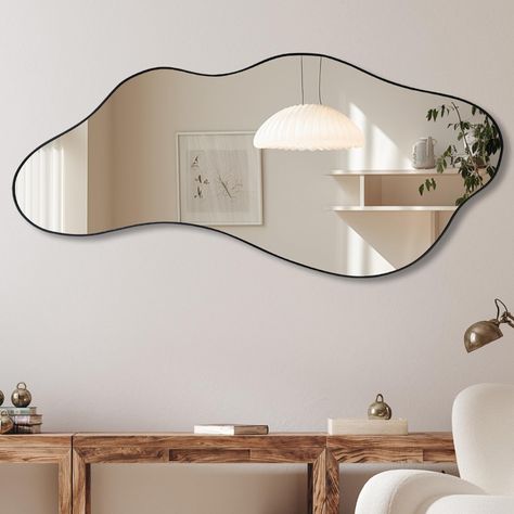 PRICES MAY VARY. Size: Black framed wavy mirror measures about 47.2 x 21.6 inches. The wall mounted mirror can be easily installed individually Suitable Scene: The irregular shape mirror is suitable for various decoration styles and improves the overall taste of decoration. This wall mirror is a perfect home decoration for fireplace, living room, dining room, vanity, entryway and so on Easy Hanging: The odd shaped mirror has hooks on the back panel to hang vertically and horizontally on the wall Amoeba Shape Mirror, Irregular Mirror Living Room, Modern Art Work For Living Room, Mid Century Modern Living Room Mirror, Cute Wall Mirrors, Tiny Hallway Decor, Minimalism Apartment Decor, Dining Room Wall Decor Mirrors, Cool Salon Decor