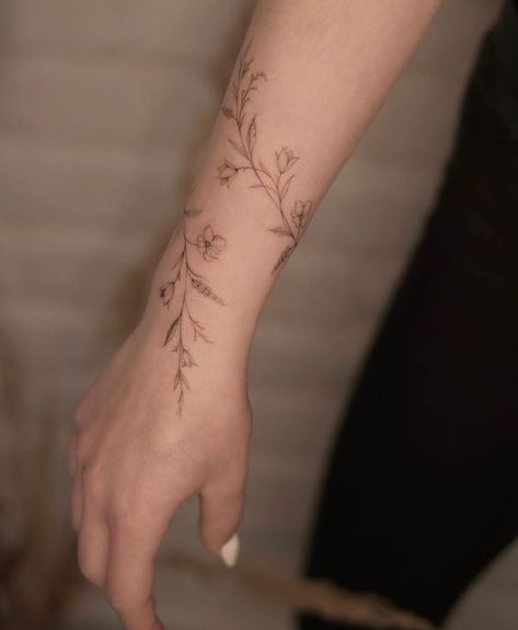 Flower Cuff Tattoo Forearm, Vine Flower Arm Tattoo, Dainty Arm Wrap Tattoos For Women, Small Wrist Wrap Tattoos, Arm Rap Tattoo, Wrapped Tattoo Arm, Botanical Wrist Wrap Tattoo, Flower Tattoo Around Wrist, Flower Arm Cuff Tattoo