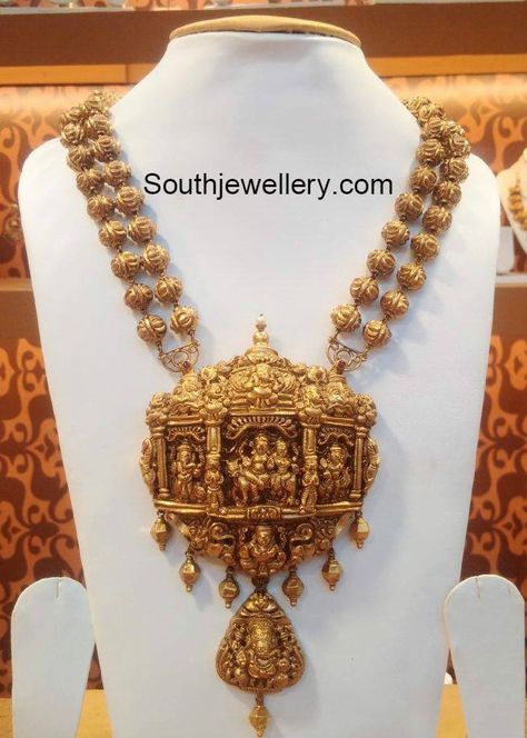 22 carat gold antique finish two line nakshi balls necklace featuring beautiful Nakshi work temple pendant embossed with Lord Shankar and Ganesh. For inquiries contact: Naj Jewellery, Nellore Email : mynaj@najindia.com Temple Jewelery, Latest Indian Jewellery, 22 Carat Gold Jewellery, Temple Jewelry Necklace, Gold Temple Jewellery, Antique Gold Jewelry Indian, Antique Jewellery Designs, Gold Necklace Indian Bridal Jewelry, Antique Bridal Jewelry